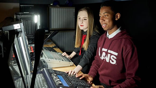 picture of music students sat at mixer desk
