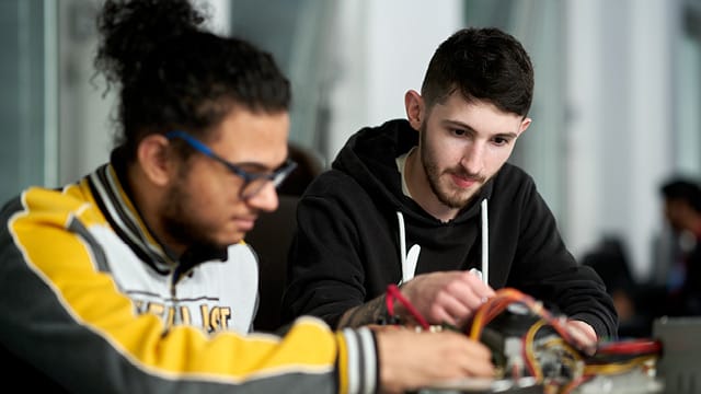 two students sat at desk