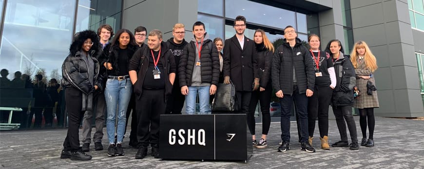 group shot of students outside Gymshark HQ facing