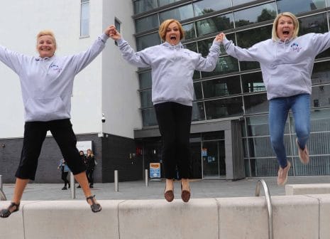 three female staff practice charity sky jump mtion