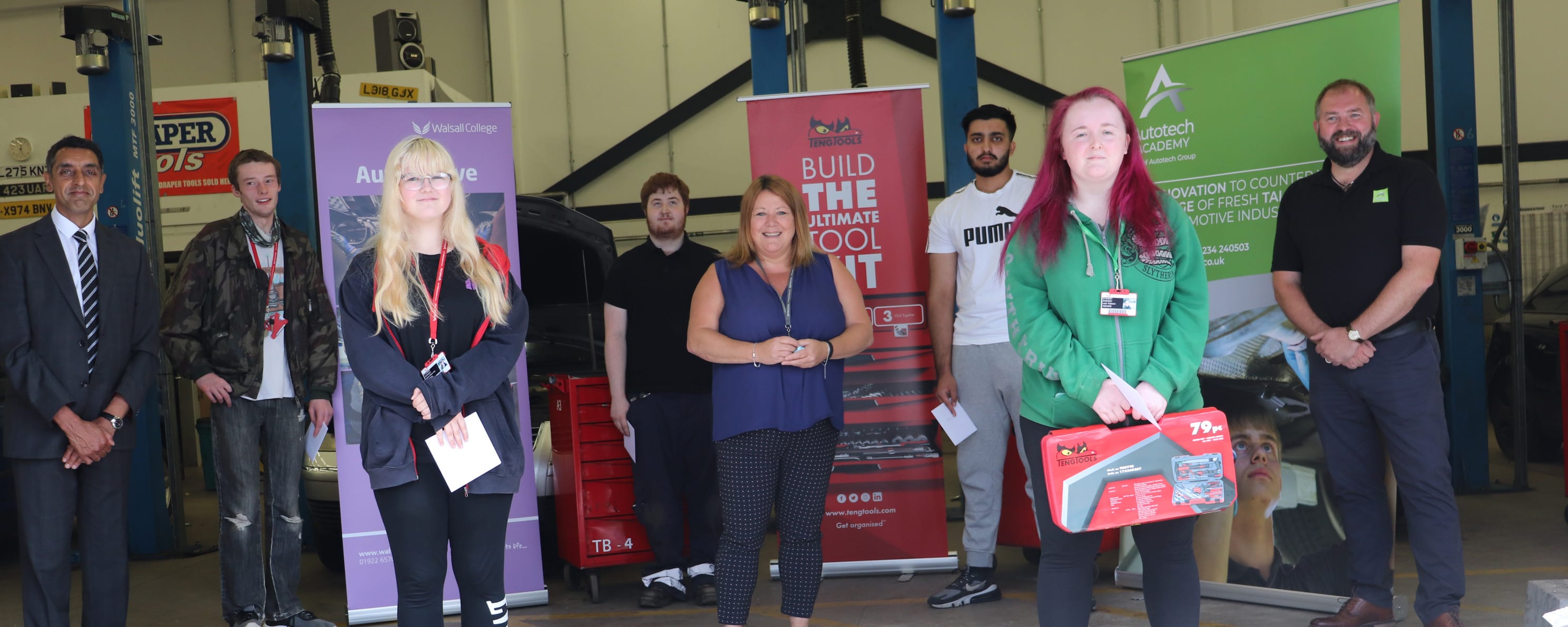 automotive student competition winners in workshop facing