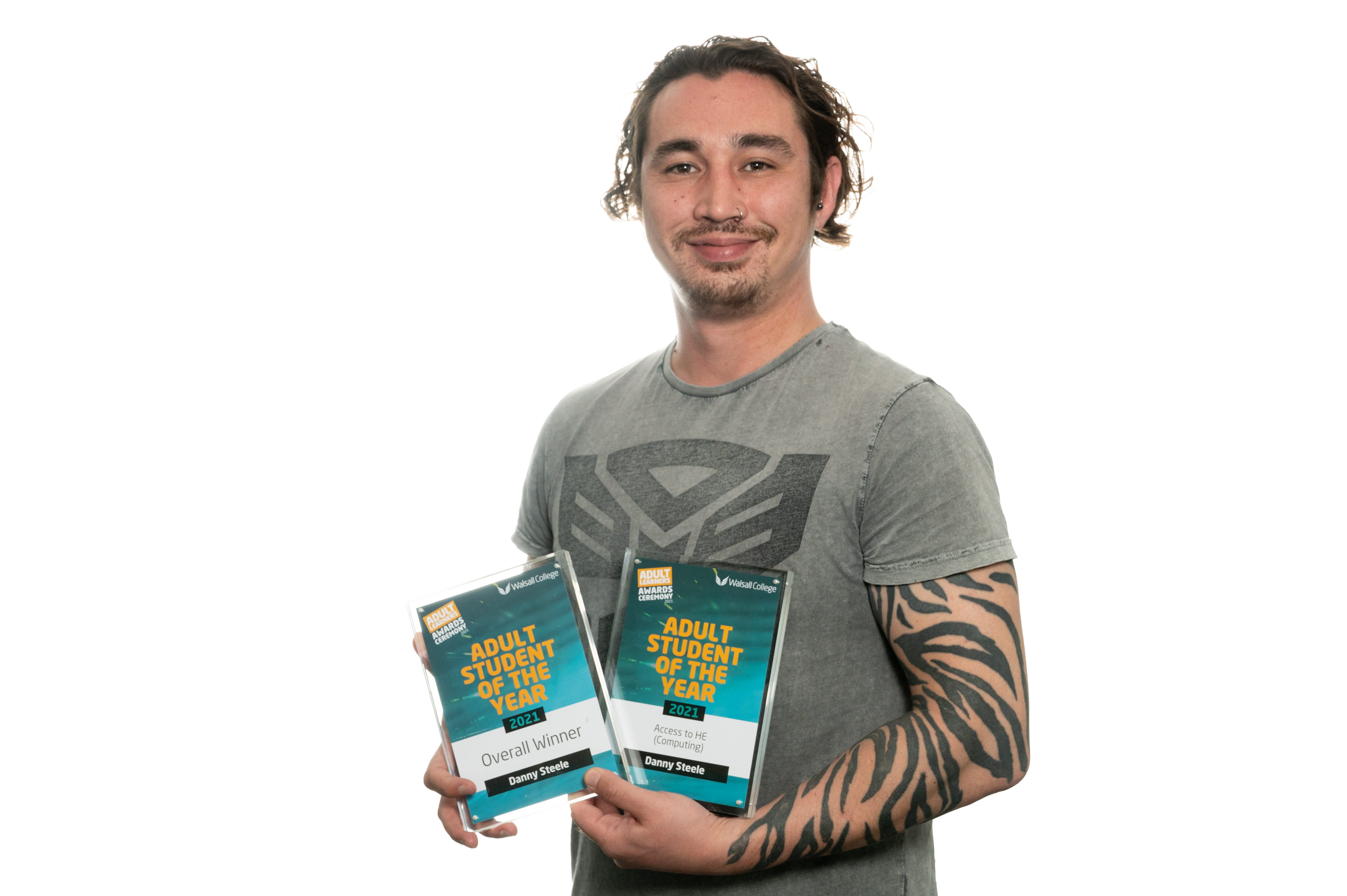 male adult student of the year with his awards facing