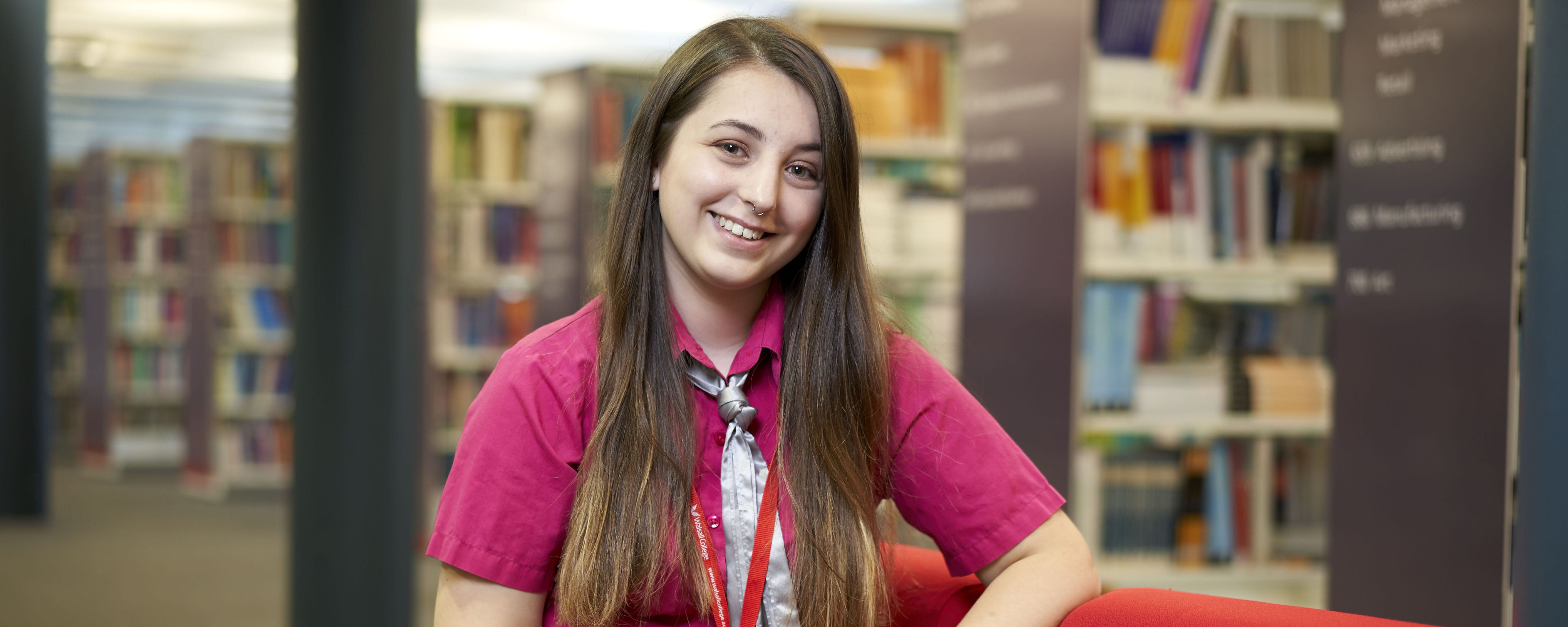 female student in library setting facing