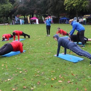 sports students leads exercise drill in arboretum