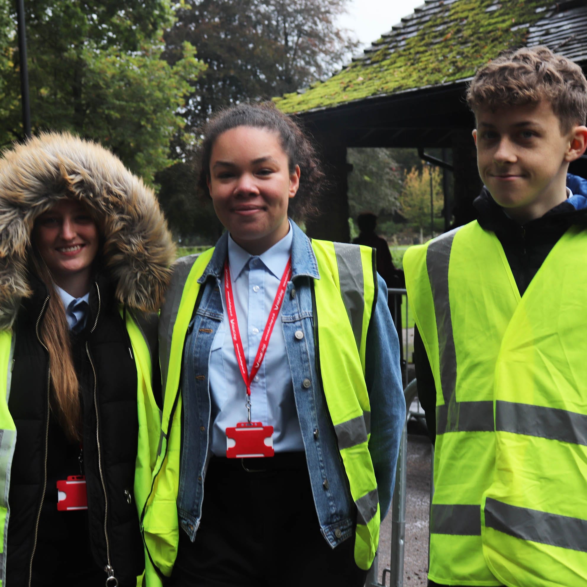 three protective services students in hi-vis facing