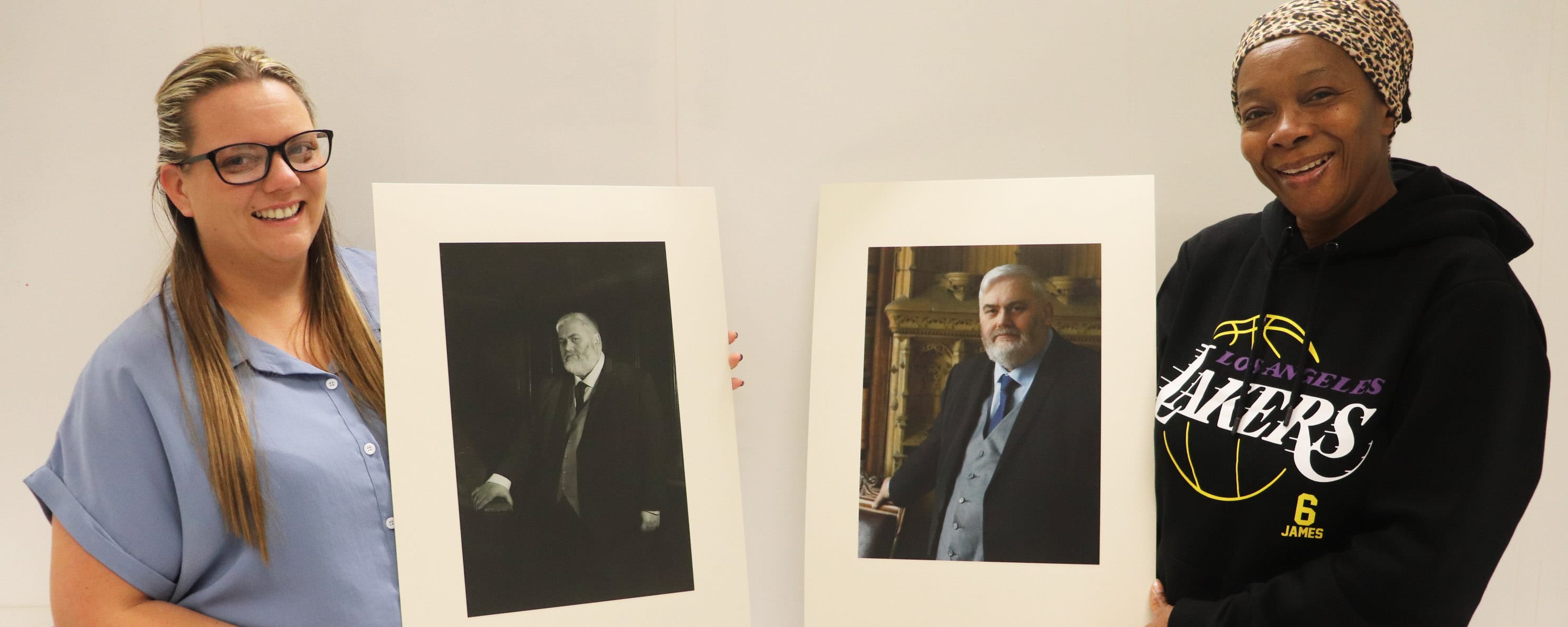 female higher education students with their mayoral portraits facing