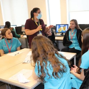 Walsall Manor Hospital staff member in classroom conversation with Health T Level students