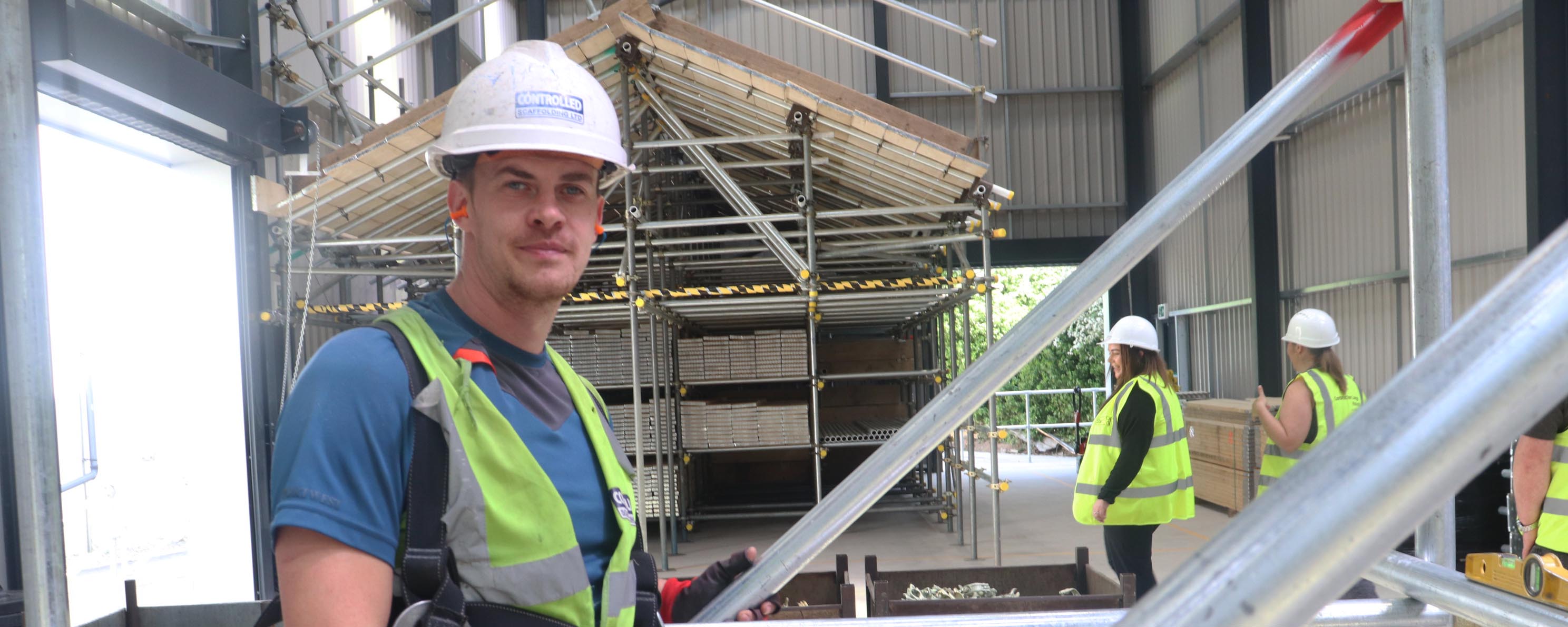 David Collins male in scaffolding training facility facing