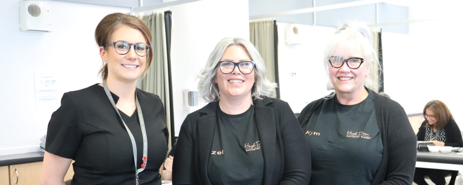 two female HD Professional Nail Systems representatives with female beauty lecturer