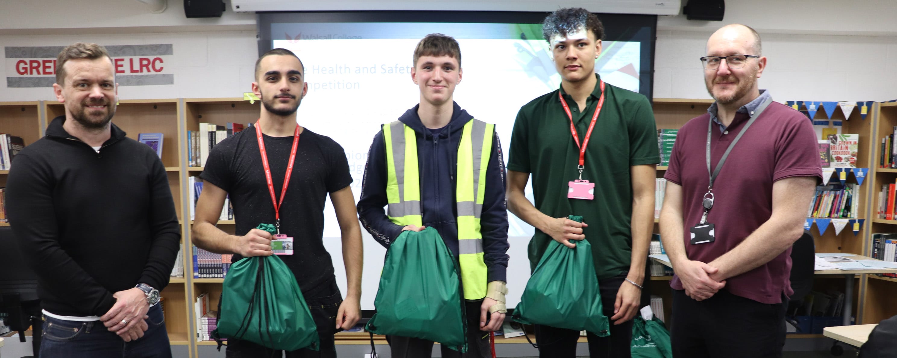 electrical student competition winners with college staff and event sponsor facing