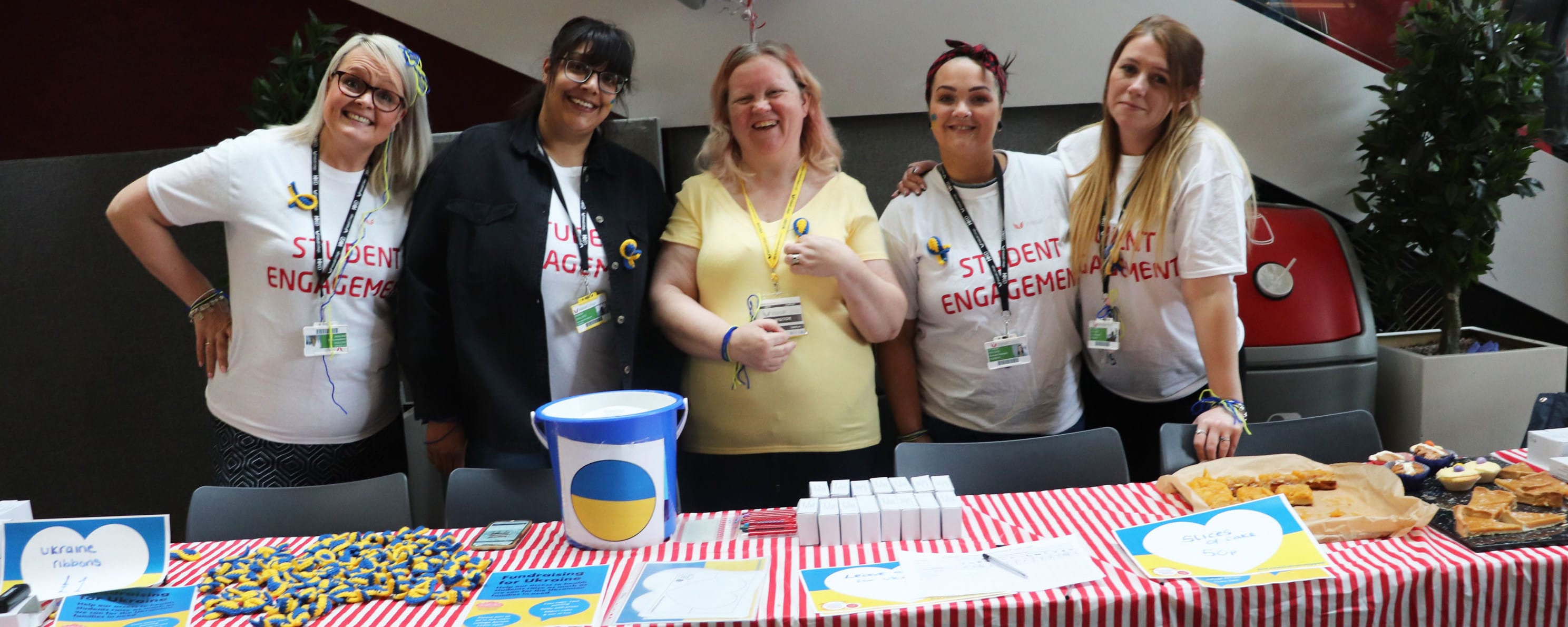 group shot of access to higher education students in front of fundraising stand