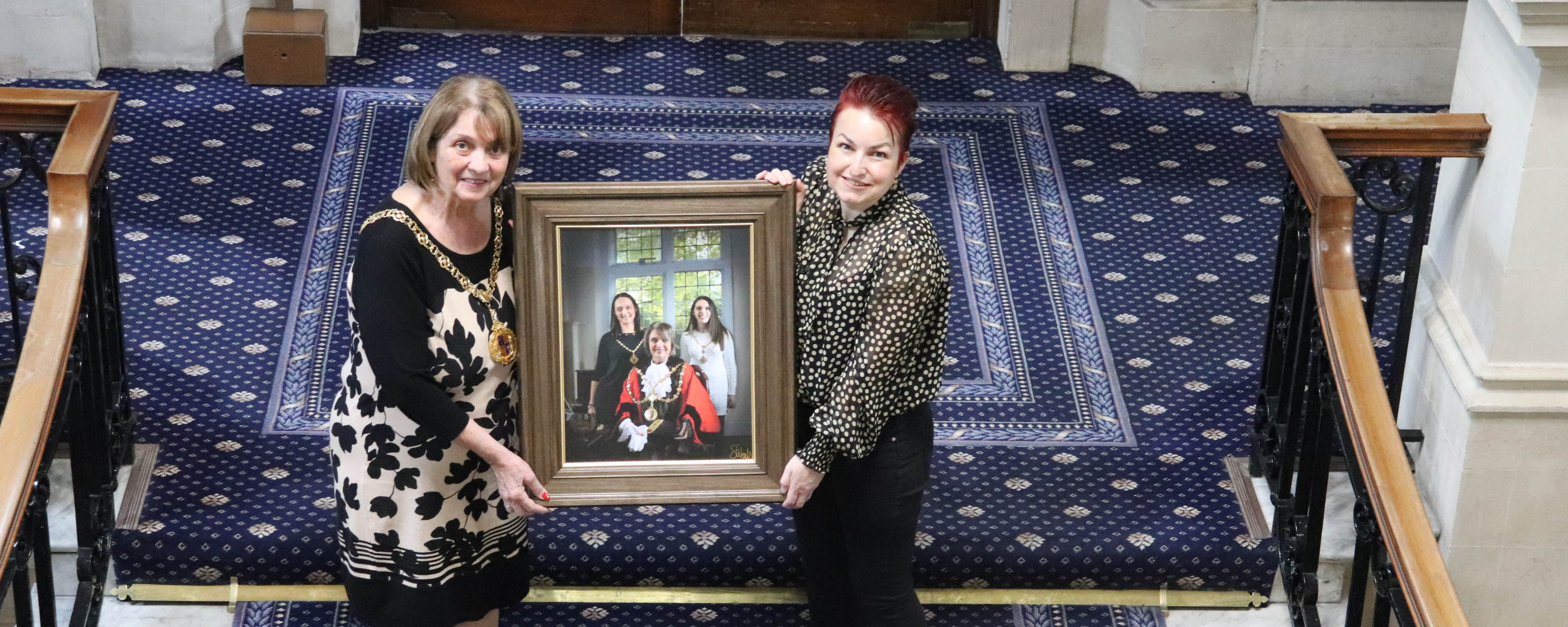 female photography student with walsall mayor holding portrait facing