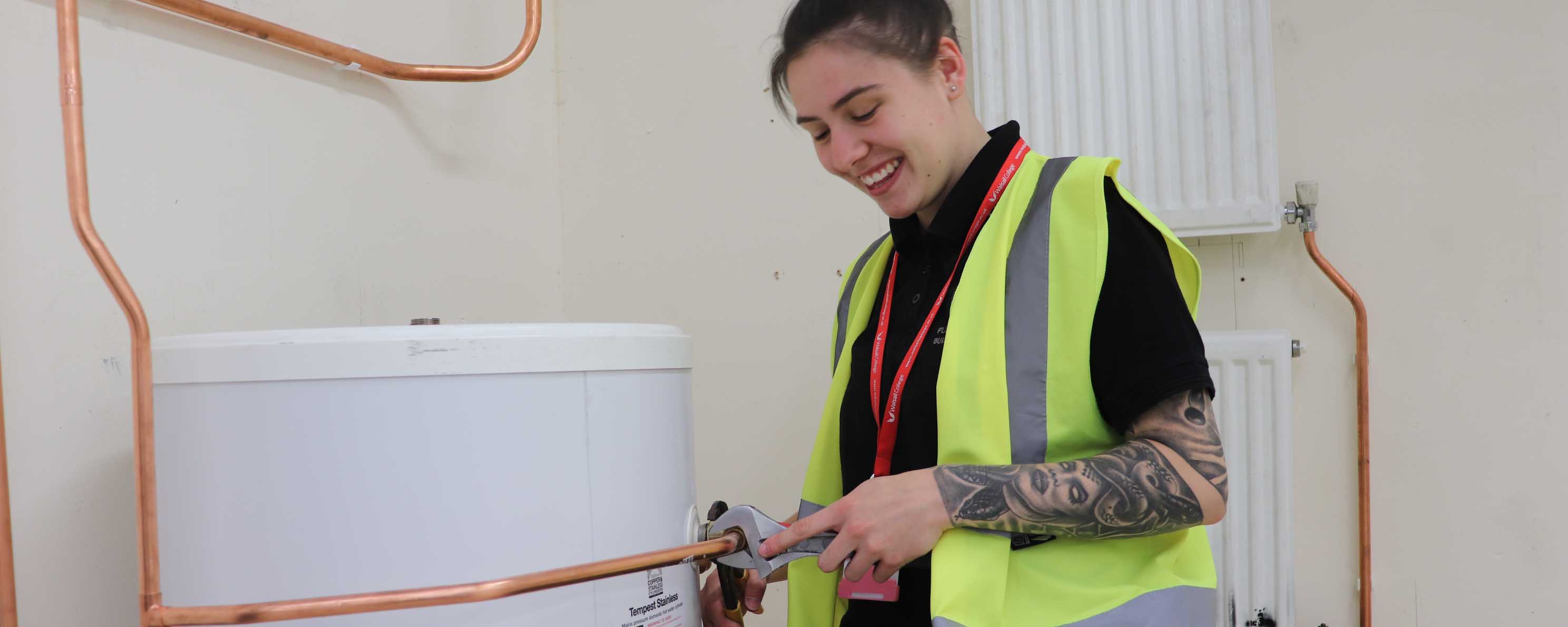 female apprentice plumber at work