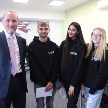 Eddie Hughes MP with three T Level students