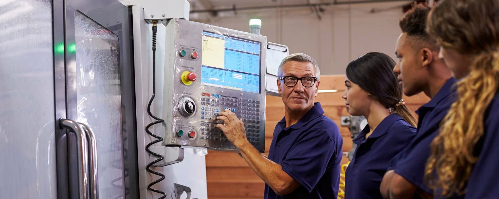 engineering lecturer demonstrates equipment to apprentices