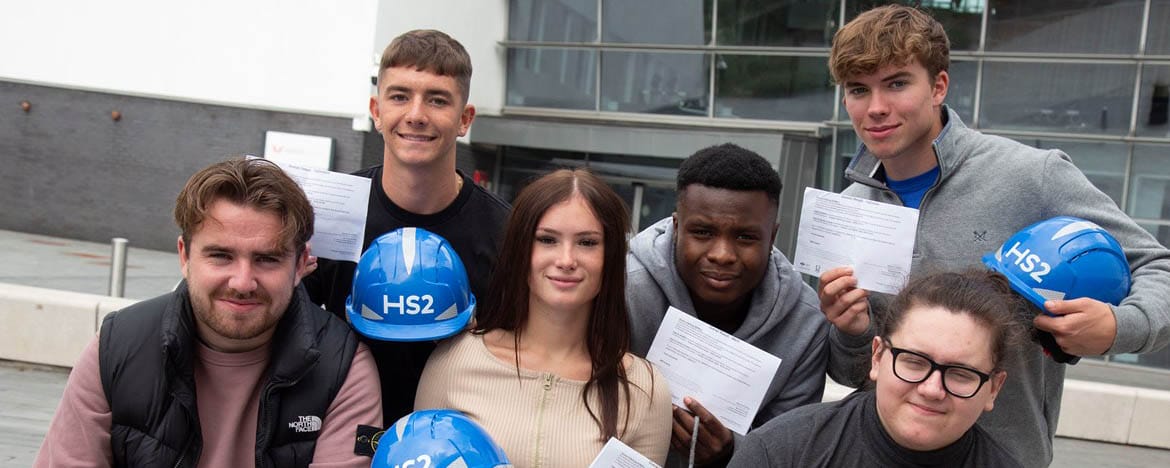 T level students post with HS2 hardhats
