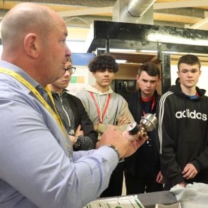 plumbing industry representative demonstrates equipment to students