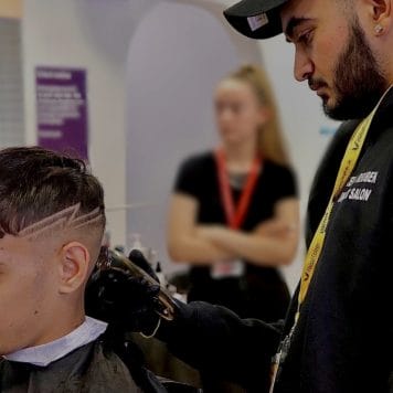 barber using razor on back of client's head