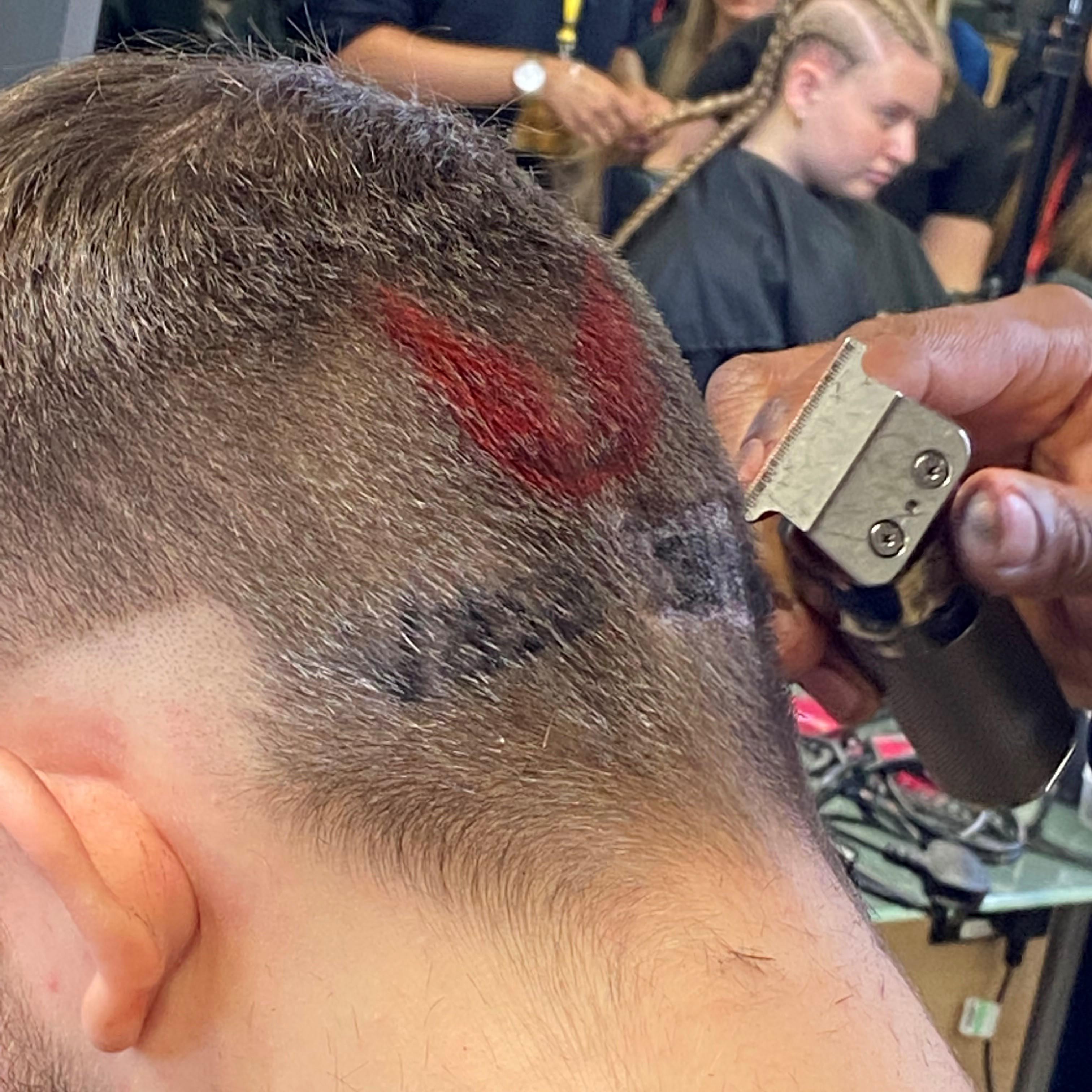 Walsall College logo being shaved into model's head