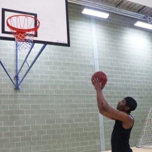 basketballer aims at net with ball in hands