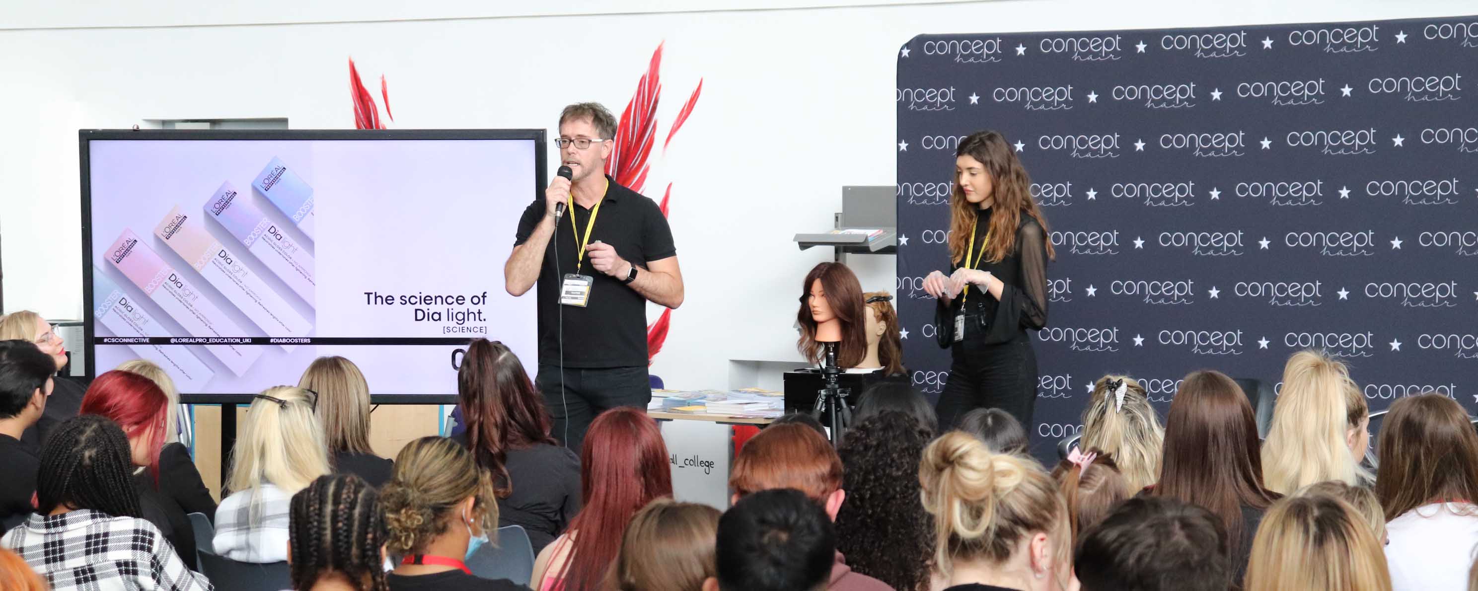 Concept Hair roadshow representative on stage addressing audience