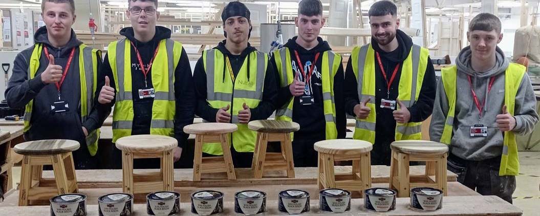 carpentry students pose with stool and Liberon paste