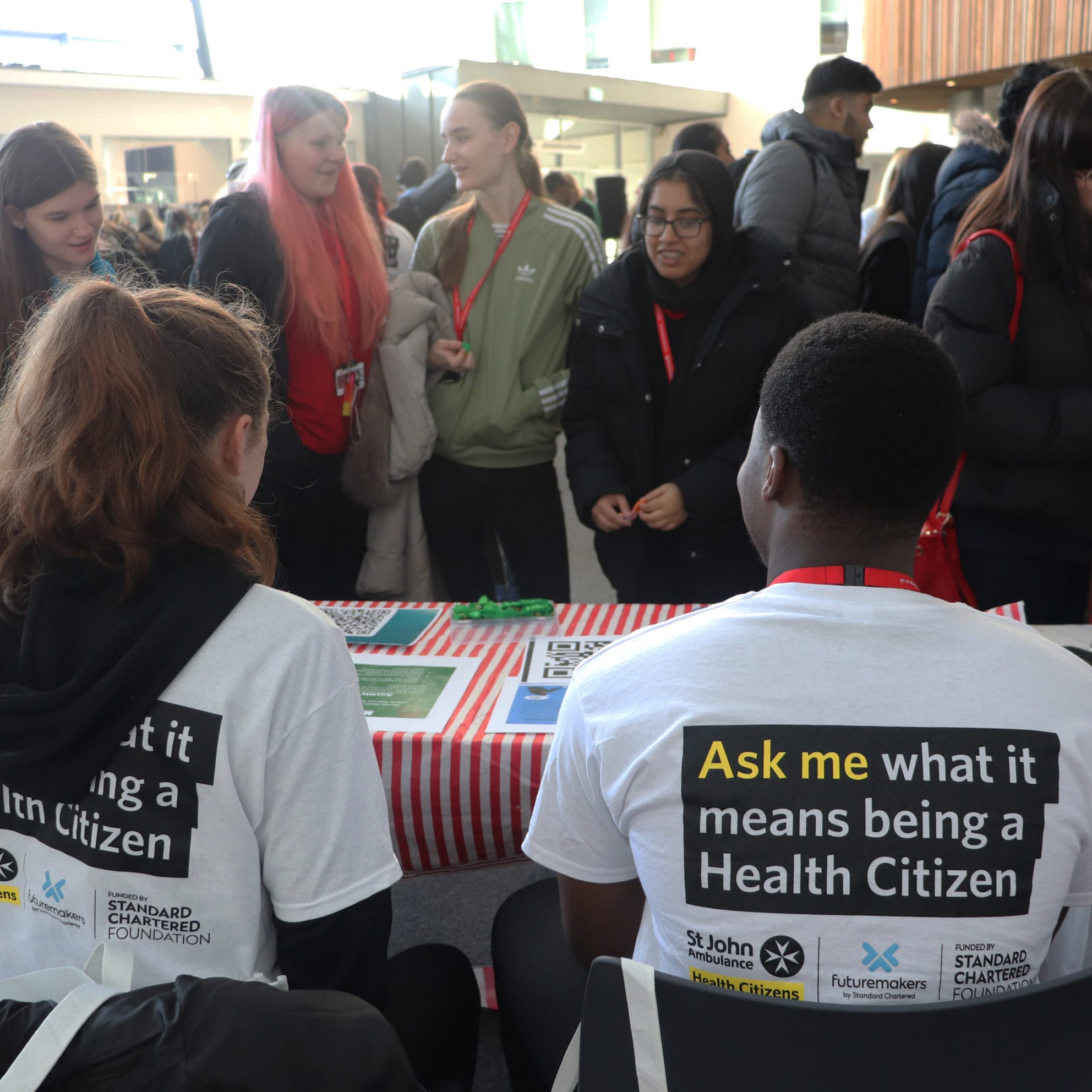 student exhibitors and visitors at Health Citizen event facing