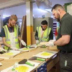 Painting and decorating students carry out a repair technique with James Lester, Repair Care International