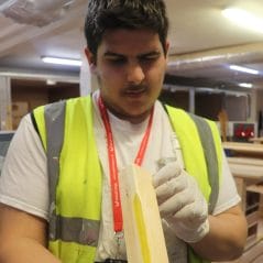 Painting and decorating student carries out repair technique 