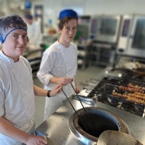 Two students chefs in kitchen