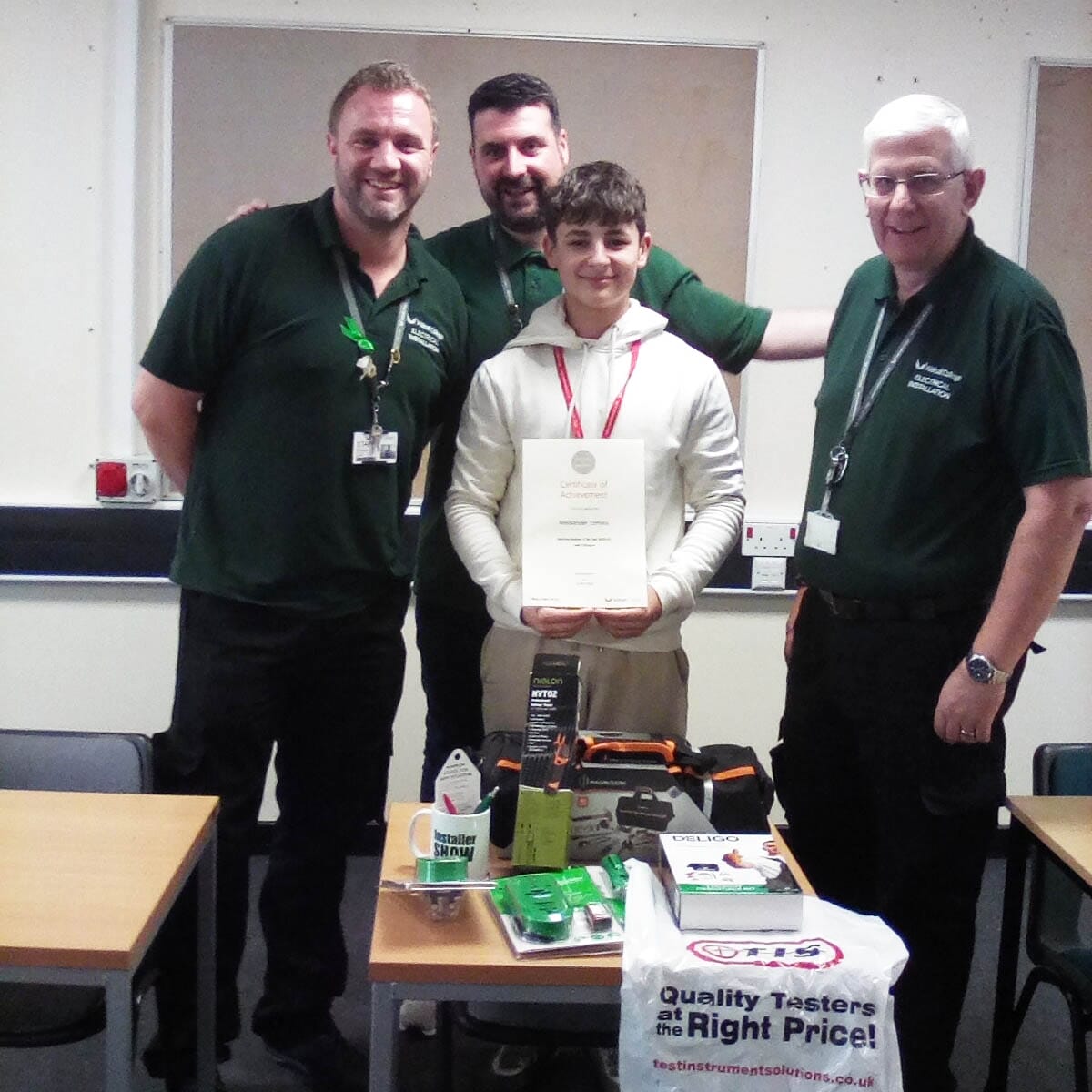  Two electrical installation faculty team members with student, Aleksander facing. 