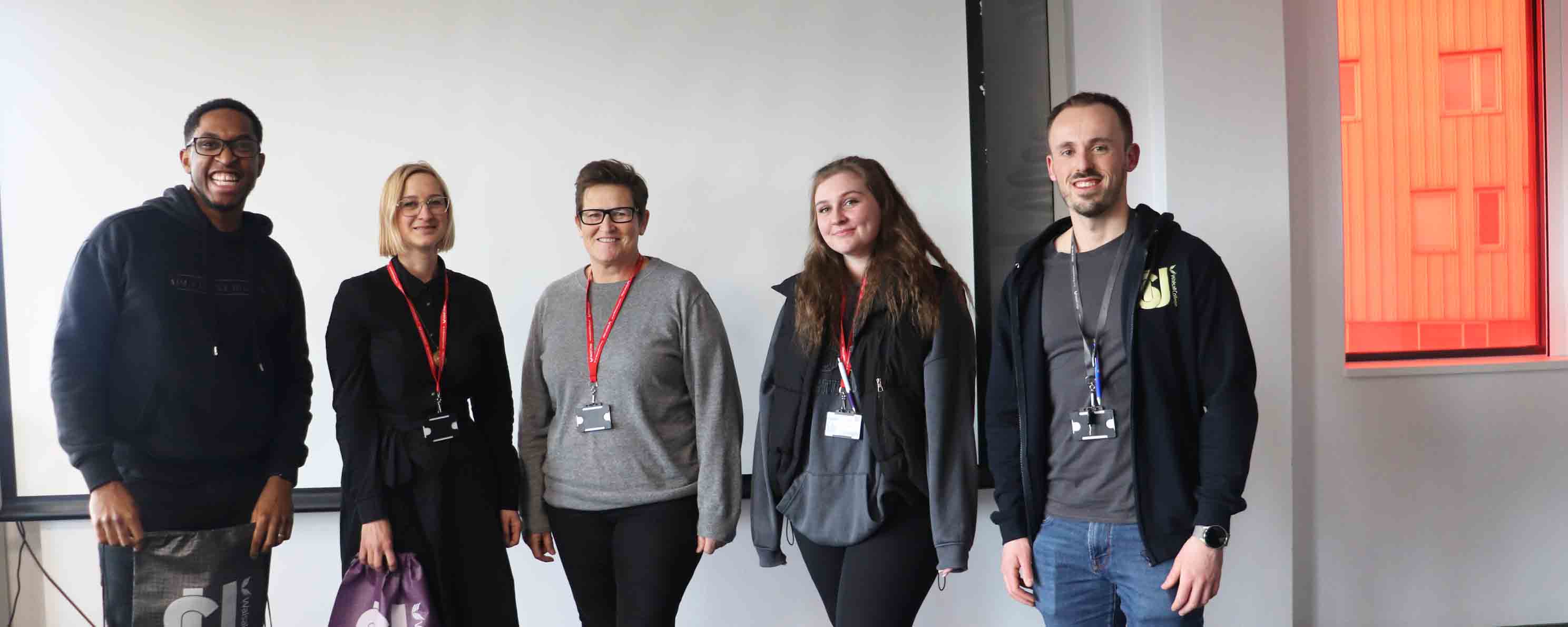 group shot of female apprentices with guest speaker and college staff facing