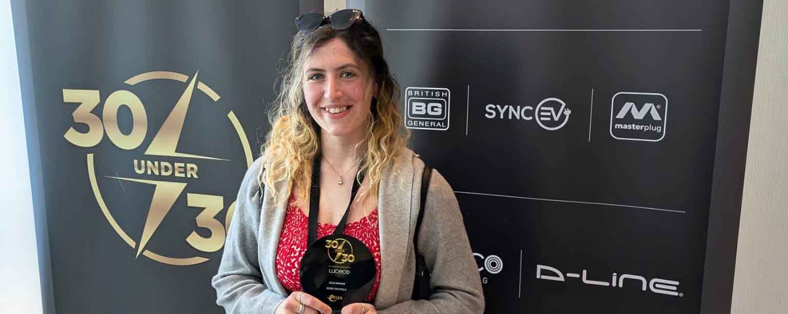 female apprentice holds award facing