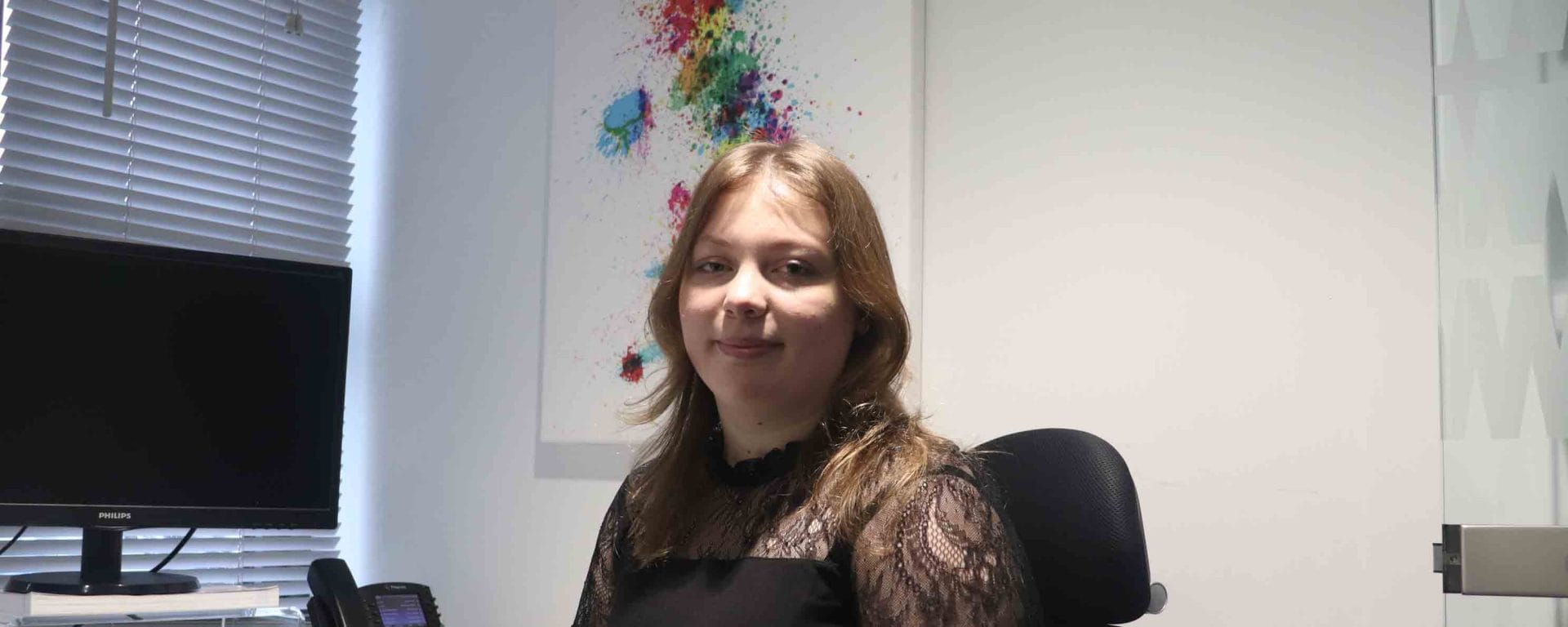 female seated in front of PC facing