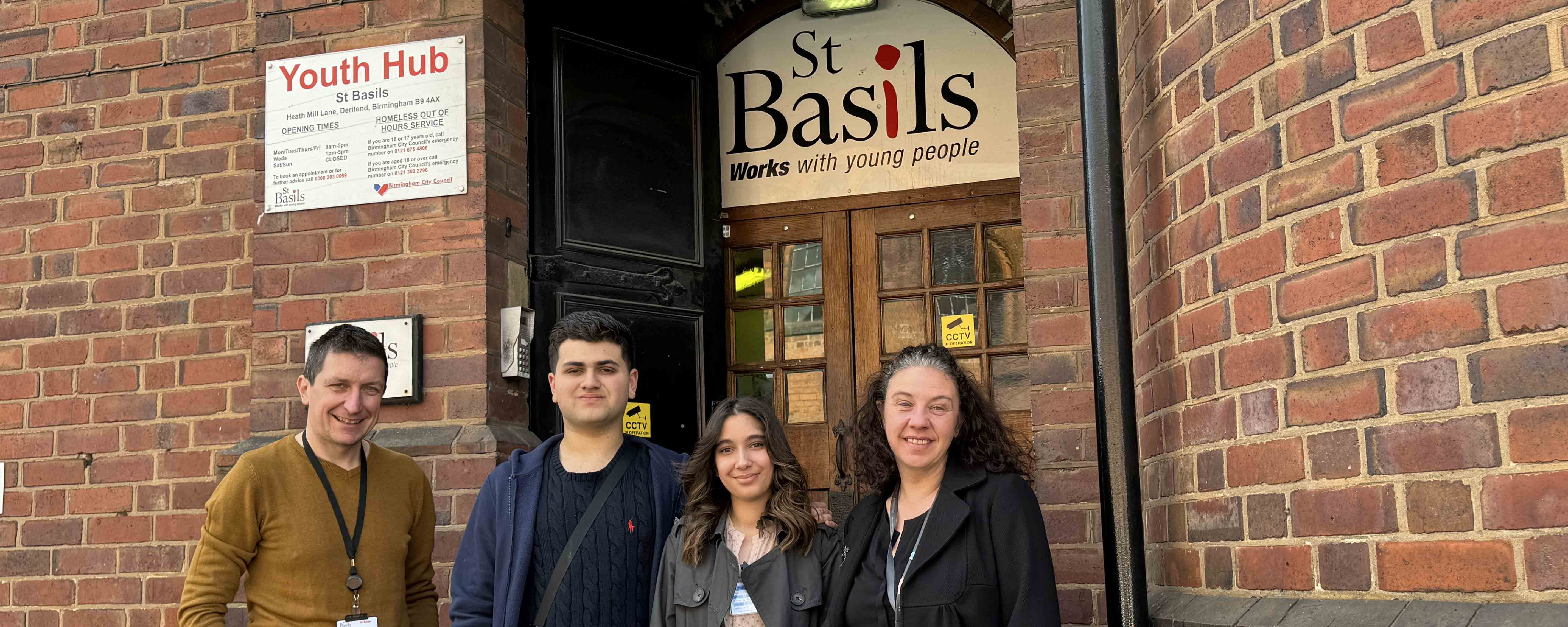 male and female student with male employer and female placement officer outside placement office