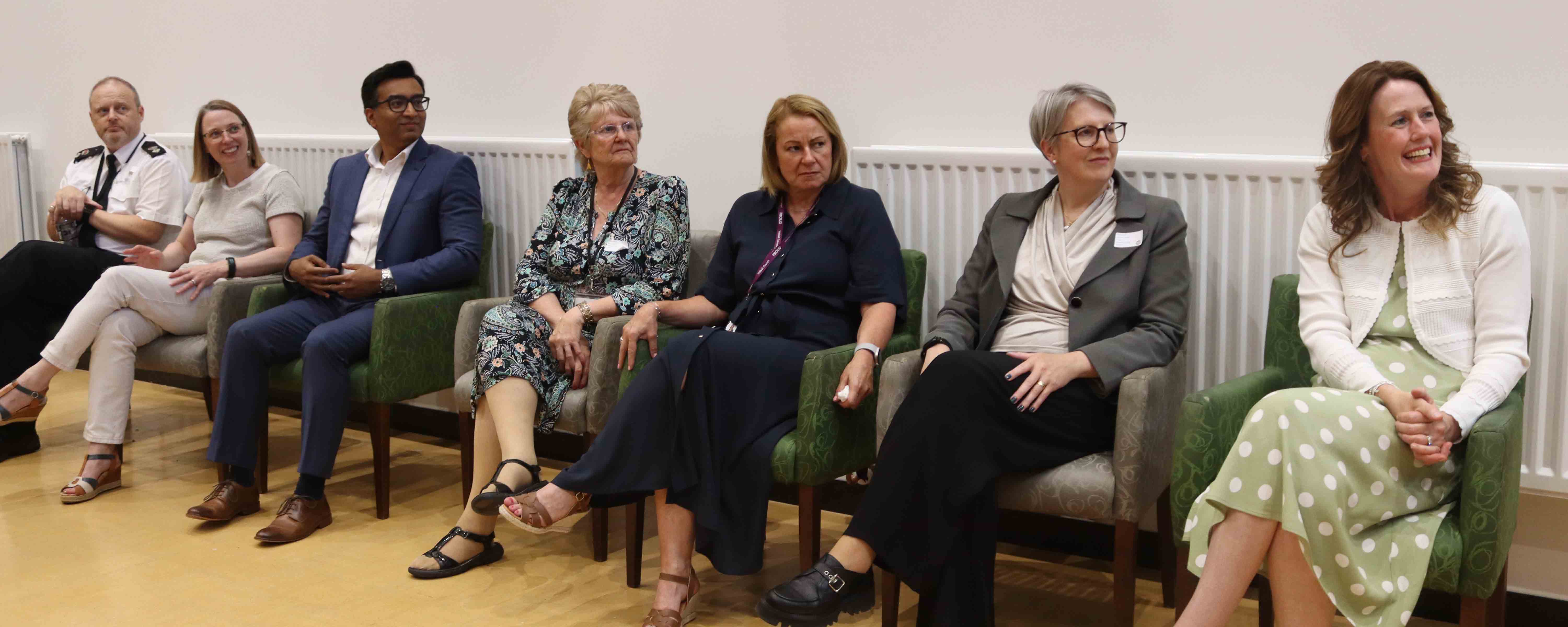 panel speakers seated in a row