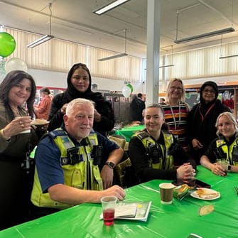 event guests around a table with other sin a row behind them
