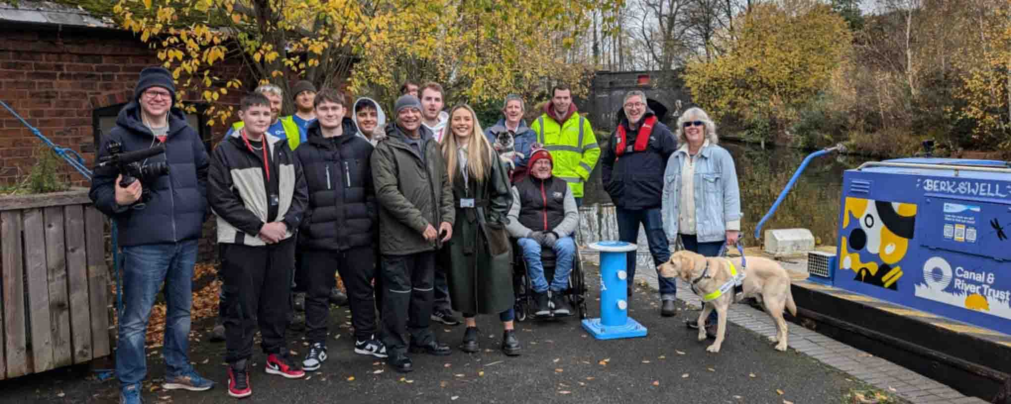 group of people standing by canal