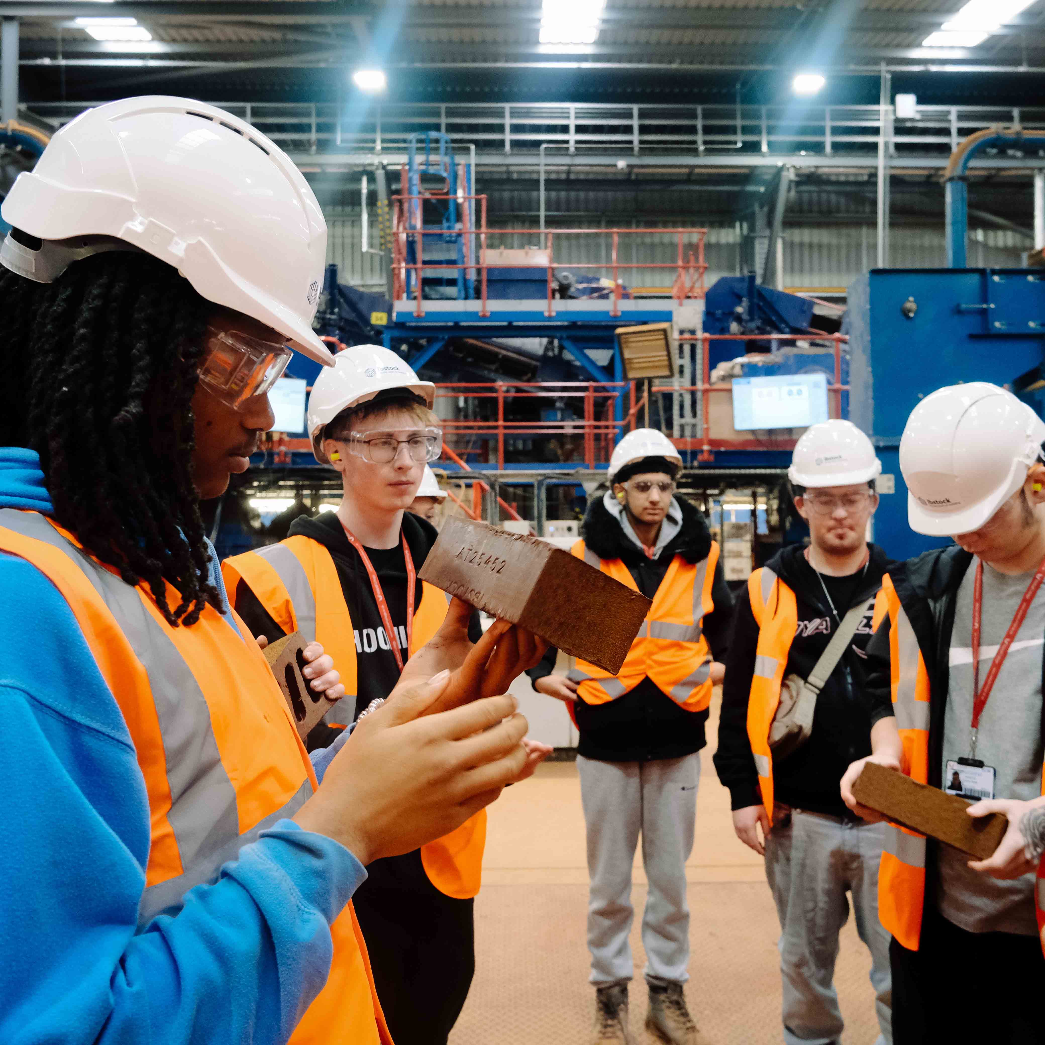 students examining bricks in their hands