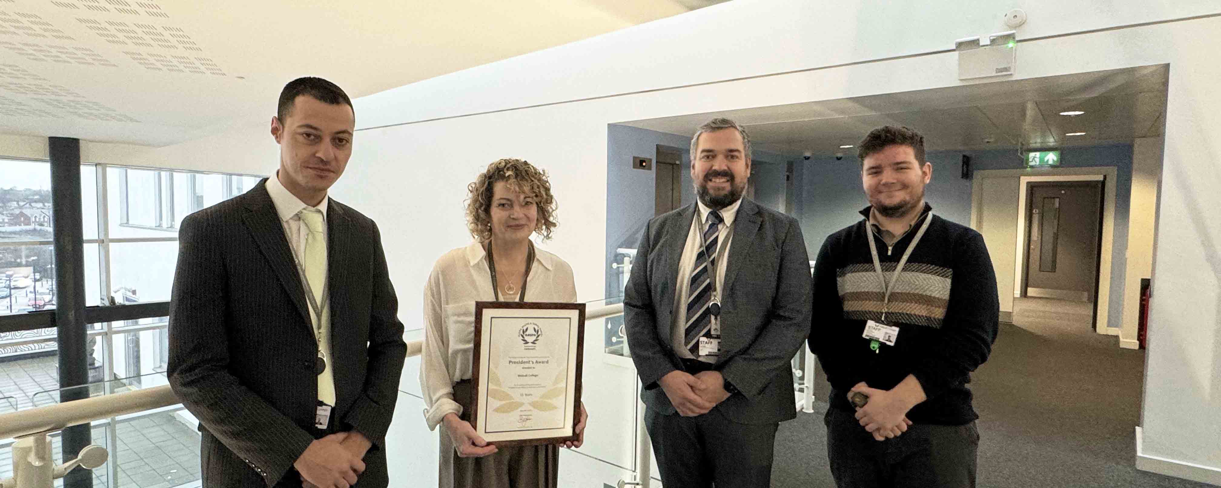 three males and one female staff member pose with RosPA Award